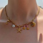 گردنبند استیل اویزدار ستاره ذریایی و مروارید و صدف رنگ طلایی